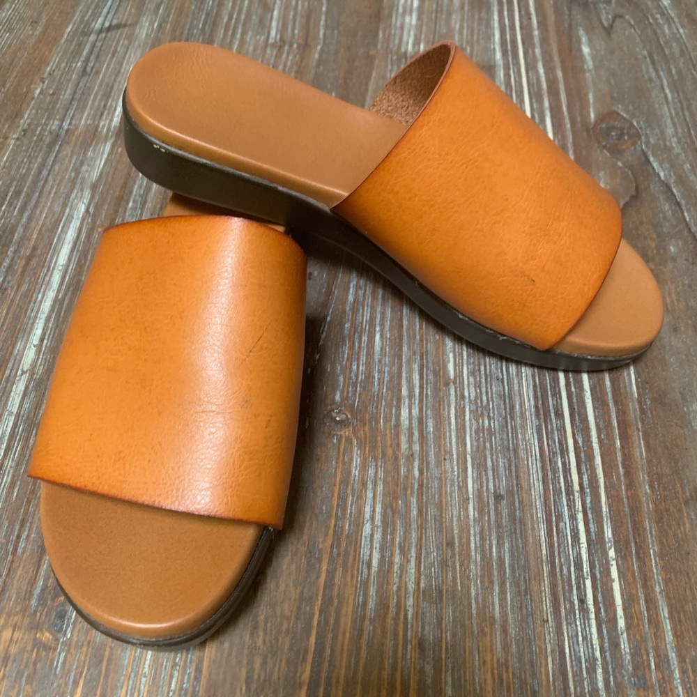 Bamboo brand faux leather slides.